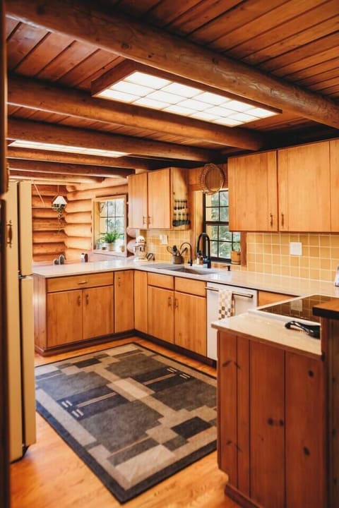 The fully stocked kitchen is newly renovated with natural stone countertops and a handmade yellow tile backsplash. It also boasts new stove and dishwasher and additional appliances such as a kitchenaid mixer for easy cooking and baking.