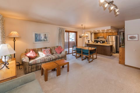 Unwind in your spacious open-concept living area with cozy seating, full kitchen, and warm mountain ambiance perfect for memorable gatherings.