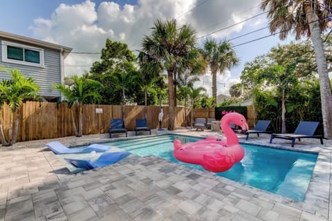 Enjoy the heated pool with sunshelf and chaise loungers. 