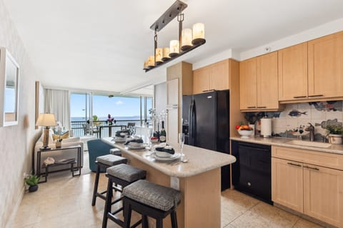Well-equipped kitchen with a breakfast bar offering fantastic ocean views.