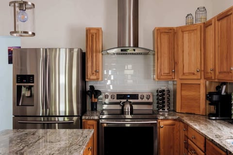 Welcome to your home chef’s paradise! This bright, fully stocked kitchen makes meal prep a joy — gather loved ones around the spacious island, brew morning coffee together, and create delicious memories in the heart of your Indy stay.