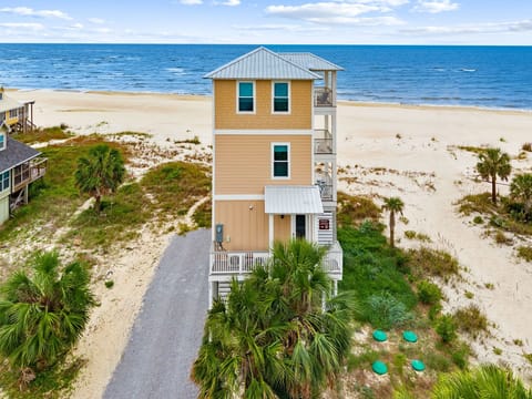 Stunning beachfront vacation home with direct beach access and panoramic ocean views from multiple levels.
