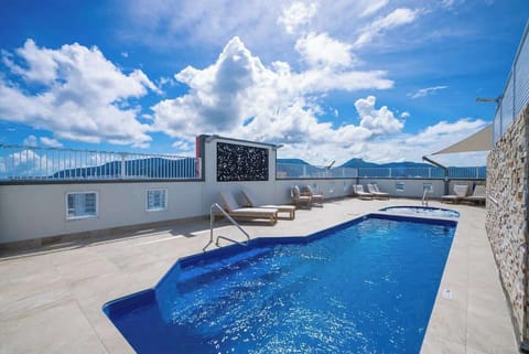The shared pool and rooftop area is the perfect place to relax under the sun.