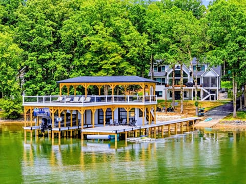 Aerial - The boathouse and home together from the water, the cove curving off to the side.