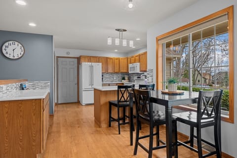 Kitchen with designated desk, breakfast bar, high top table