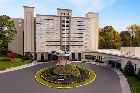Daytime view of Alloy building with round drive and landscaped entry