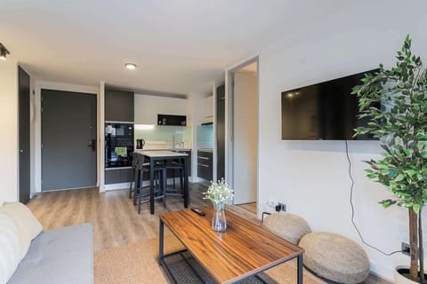 Cozy and modern living space with a sleek kitchen, perfect for relaxing after exploring the city.