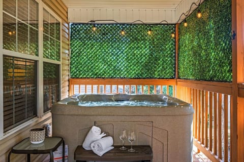 Enjoy your own private hot tub retreat, surrounded by lush greenery for added privacy. Perfect for relaxing after a long day, this cozy space features soft lighting, fresh towels, and even wine glasses for a peaceful soak under the stars.