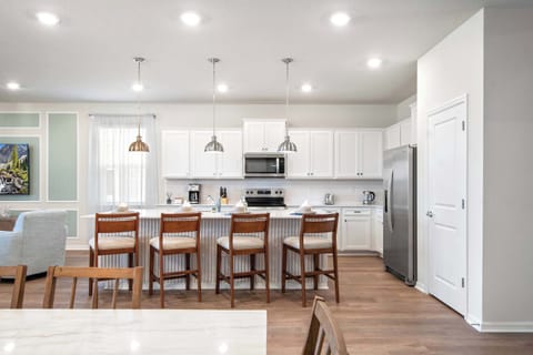 Bright, modern kitchen with stainless steel appliances and spacious breakfast bar.
