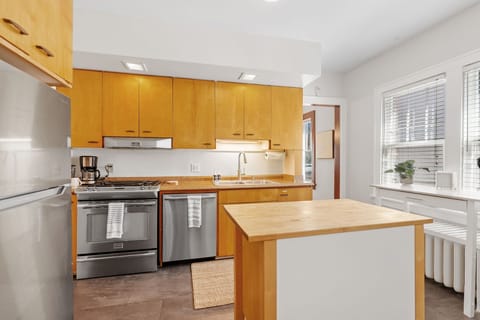 Your bright, modern kitchen features warm wood cabinetry and stainless appliances, perfect for preparing your favorite meals during your stay.