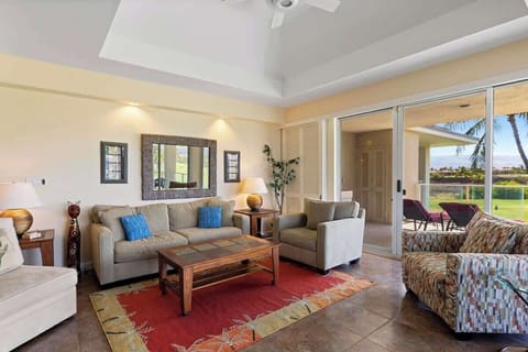 Gather with family and friends in this stylish open concept space with tropical textures and patio access.