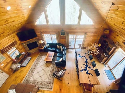Living room from 3rd level. New leather couch. Warm easy on (switch) fireplace. Locally sourced wood table with Deep Creek inlay just custom designed by a local craftsman.