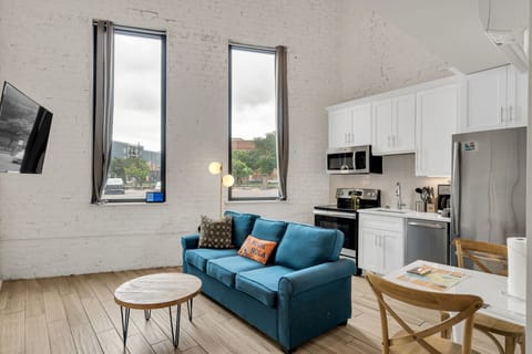 Kick back in a soulful living room with high ceilings, classic architectural touches, and the spirit of New Orleans just outside your window