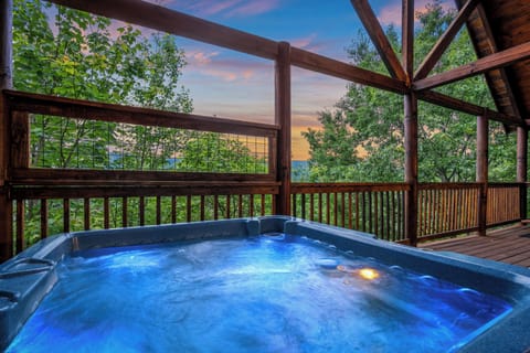 Relax in the outdoor hot tub with mountain views.