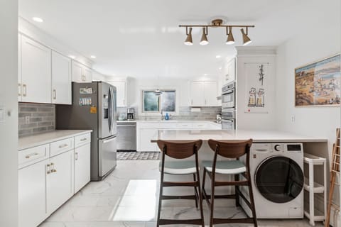 The fully renovated kitchen with wall oven and microwave, reverse osmosis drinking water, extra clothes washer, and dishwasher. Seating for 2 at the peninsula. Coffee provided!