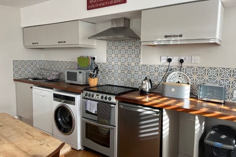 A fully equipped kitchen open-planned to the living room.