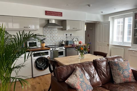 A fully equipped kitchen open-planned to the living room.