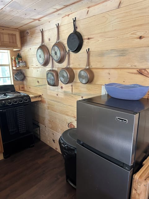 Kitchen with stove, fridge, pots, pans, and cooking essen