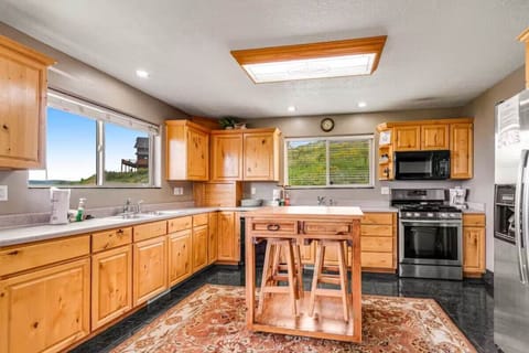 Prepare breakfast with a view in this warm, wood-appointed kitchen with modern appliances and an island for casual dining.
