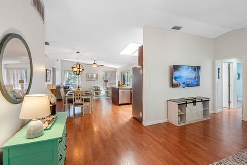 The living room offers a harmonious blend of modern technology and cozy comfort, making it an ideal space for relaxation and entertainment.