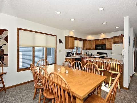 Spacious dining area with seating for the whole group, seamlessly connected to the kitchen for easy entertaining.