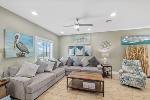 Unwind in your coastal-themed living room where nautical art and plush sectional seating create the perfect beach house retreat.