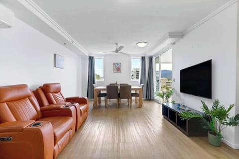 Relax in the minimalist living area, where leather recliners and a mounted TV set the scene for easy evenings in.