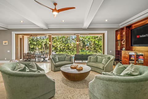 This 5-bedroom villa blends luxury and island charm, with a private heated pool surrounded by lush tropical gardens