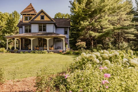 Welcome to your home away from home! The front of the house bursts with spring charm—lush greenery, colorful blooms, and curb appeal that sets the tone for a relaxing stay