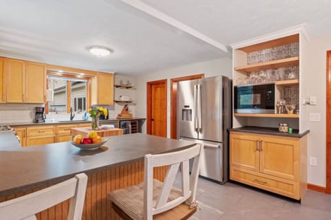Bright, fully stocked kitchen with modern appliances, island prep space, and everything needed for home-cooked meals.