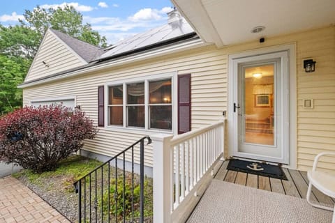 Welcoming front entrance surrounded by mature landscaping and classic New England charm.