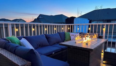 Relax at the fire table with cozy seating and warm, ambient string lighting