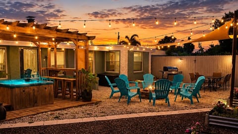 Private backyard retreat with hot tub, fire pit & outdoor dining under café lights
