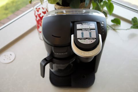 Kitchen w/ fridge, stove, dishwasher, & coffee machine (cups or ground coffee)