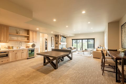 Lower level game/family room with a wet bar, microwave and mini fridge