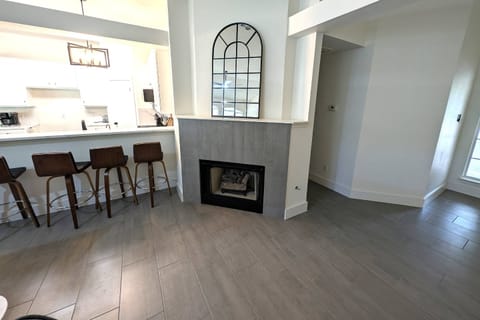 Open concept with barstool seating and fireplace