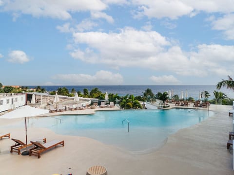Relax by the infinity pool with stunning ocean views just steps from your suite/residence.