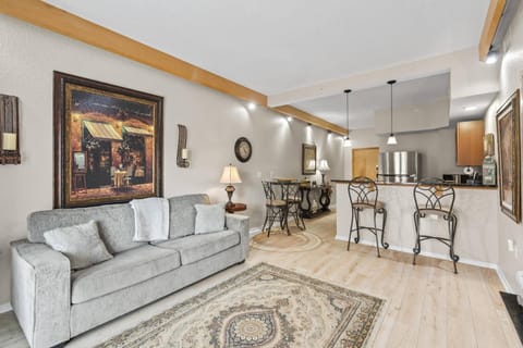 Inviting living room with open-concept design, sleeper sofa for extra guests, and patio doors leading to fresh air and natural light.