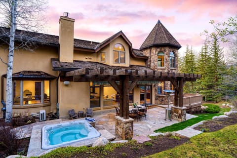 Backyard with a hot tub and outdoor dining table.