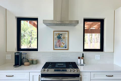 Kitchen with keurig and basic cooking spices and oils