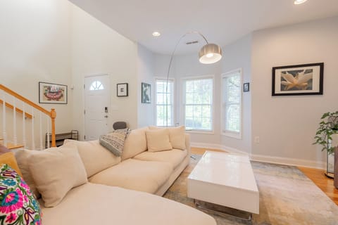 Bright living room, comfy sectional, and lots of natural light—perfect for relaxing.
