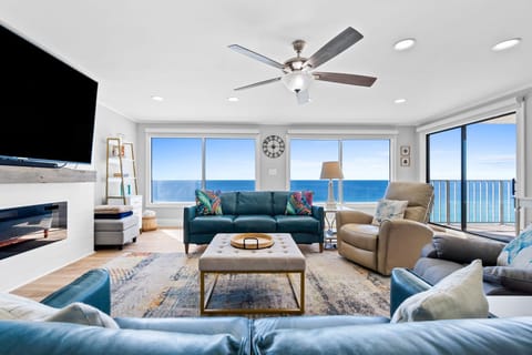 Perched on the 14th floor, this stunning living room offers panoramic views of the emerald-green waters of the Gulf
