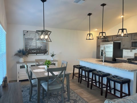 The dining room seats 4 with an additional 4 stools for a total of 8.