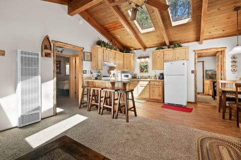 Open kitchen & dining area w/ wood beams, bar seating & an easy, welcoming flow.