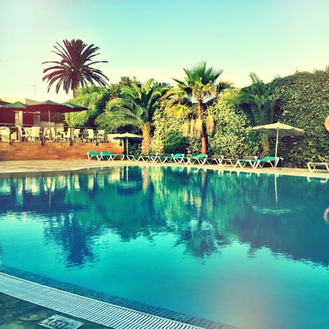Outdoor pool, open 10:00 AM to 8:00 PM, pool umbrellas, sun loungers
