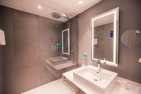 Bathtub, eco-friendly toiletries, hair dryer, towels