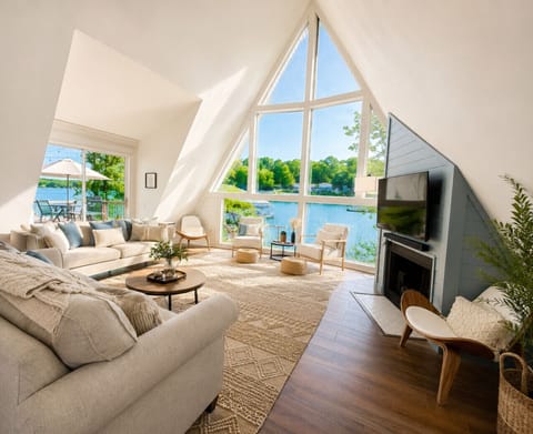 Relax at this stunning lakefront A-frame retreat featuring floor-to-ceiling windows, breathtaking water views, modern luxury interiors, private dock access, and the perfect setting for family vacations or romantic getaways.
