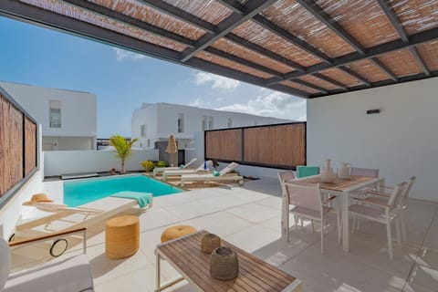 Sunny private pool with terrace area and pergola.