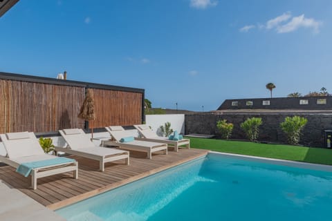 Private pool with grass area and sunny terrace.