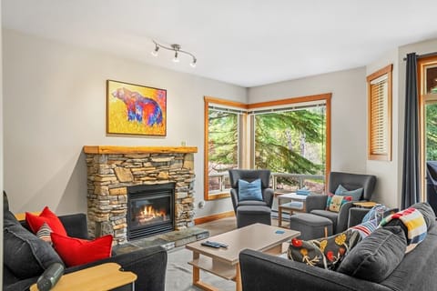 Spacious living room with a TV and a cable package, electric fireplace, board games and cozy seating to wind down after a day filled with activities with a pull-out sofa bed for extra sleeping space (all necessary bedding provided.)